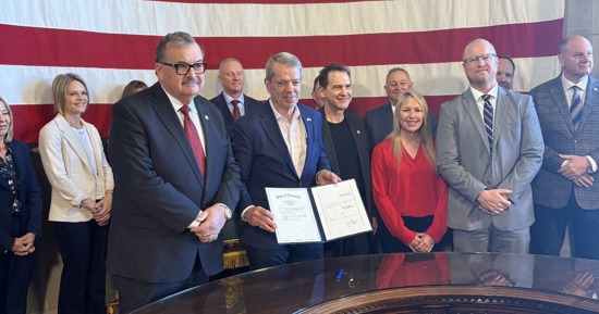 Governor Pillen Flanked by Senator Mike Jacobson (Left) and Senator Brian Hardin (Right) Showing the Signed Bill